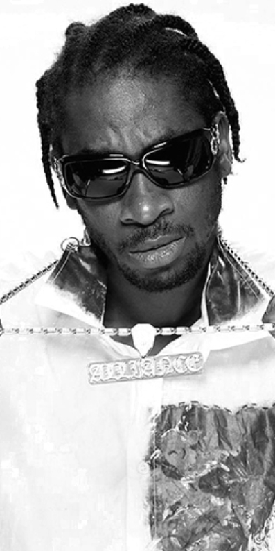 Male artist wearing sunglasses holding his chains up