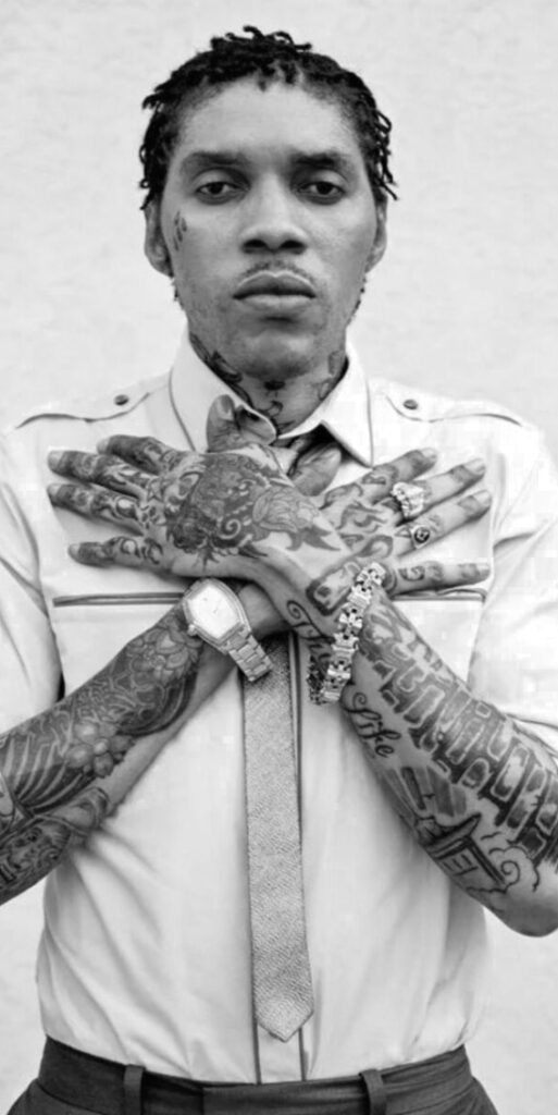 Male artist crossing his arms across his chest with tattoos.