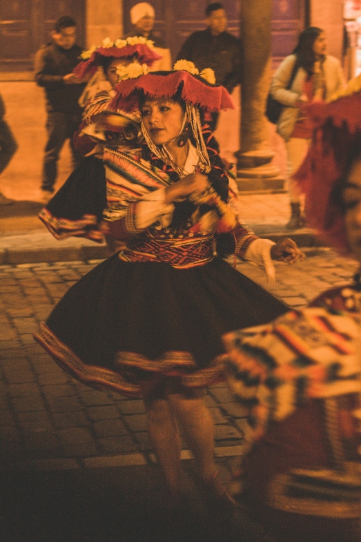 Spanish woman dancing outdoors wearing a traditional dress
